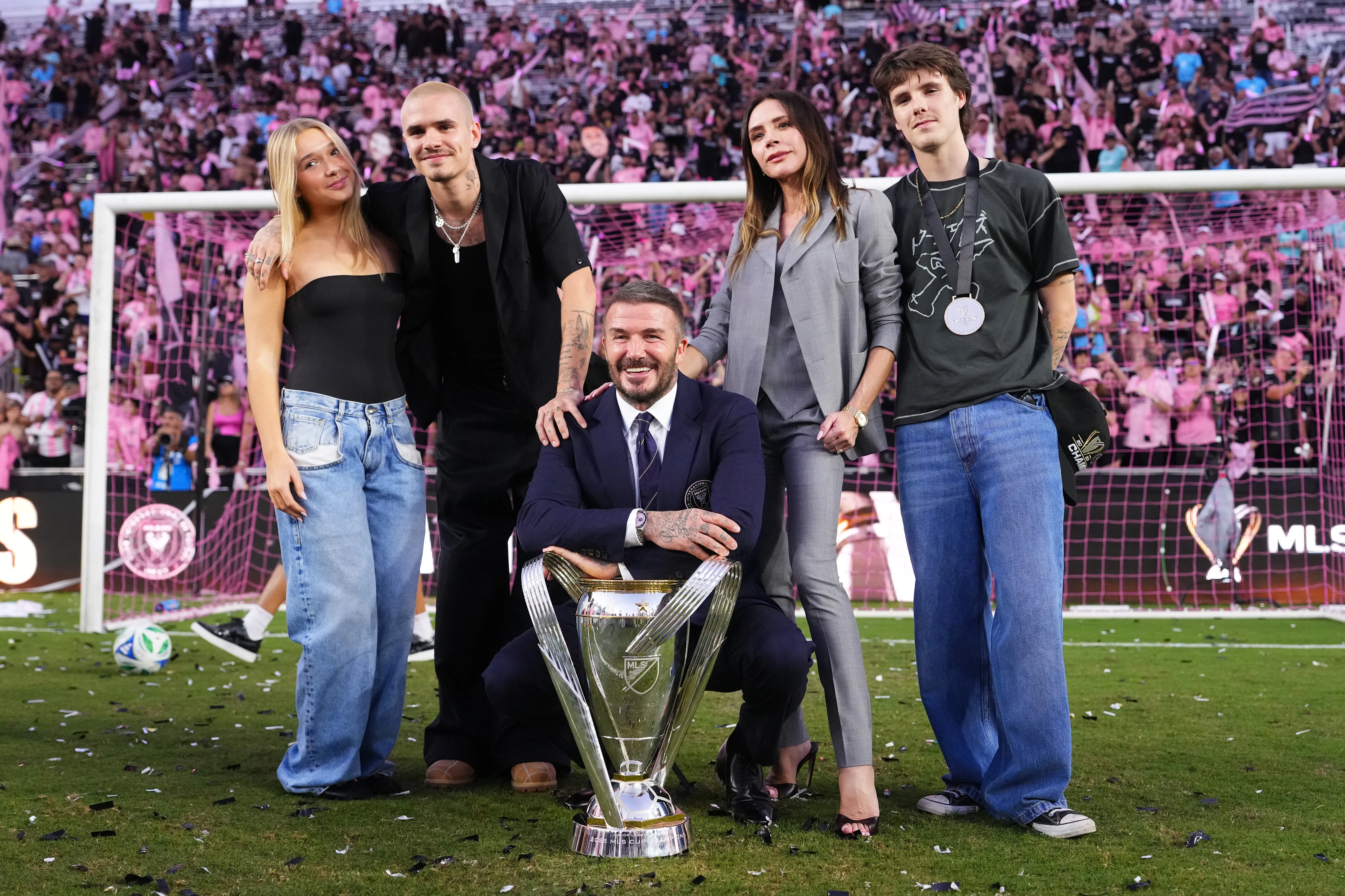 David Beckham, Victoria Beckham, and their sons Cruz and Romeo pose with the MLS Cup trophy after Inter Miami CF won the championship.