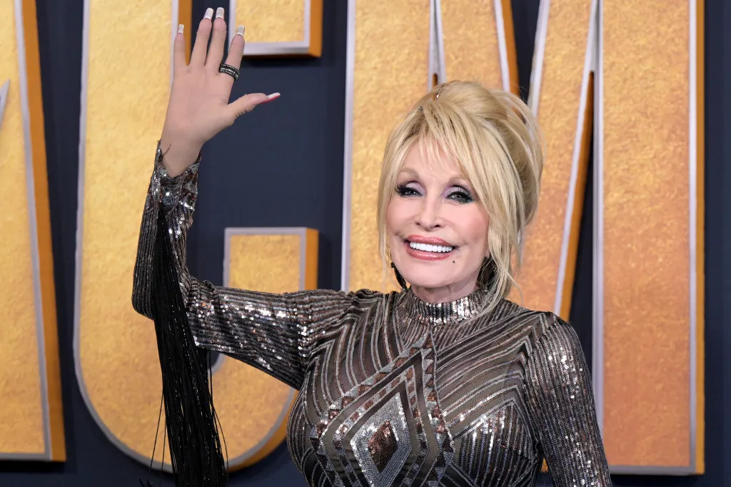 Dolly Parton smiling and waving at the 57th Academy of Country Music awards.