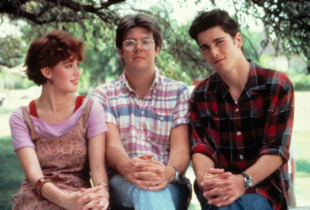 Molly Ringwald and Mark Schoeffling with director John Hughes on the set of 