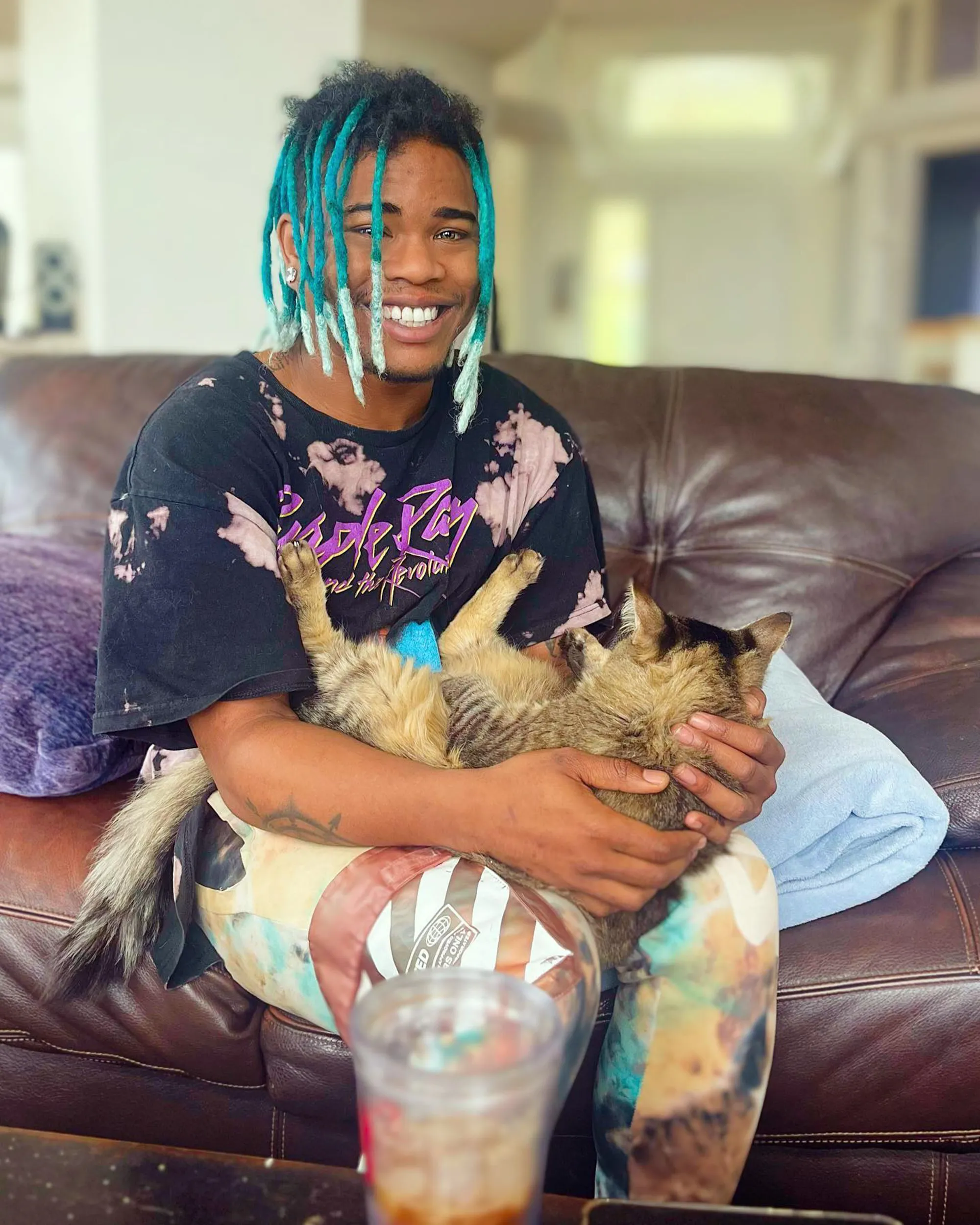 Brian King smiling while holding a cat.