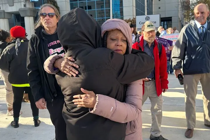 Sonya Massey's mother, Donna Massey, hugs a supporter outside the Peoria County Courthouse.