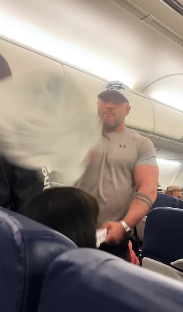 Man in gray shirt throwing something.