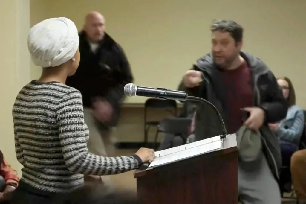 Man shouts at U.S. Rep. Ilhan Omar at a town hall meeting.