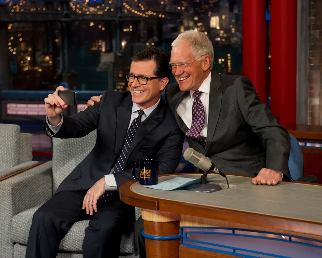 Stephen Colbert and David Letterman takes a picture during an episode of 