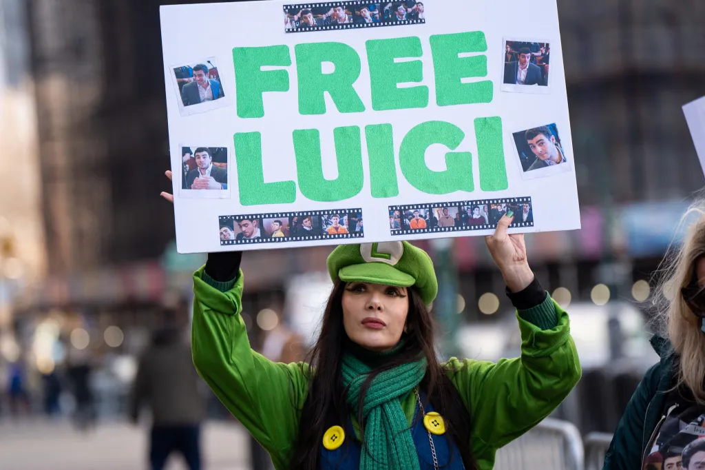 A supporter of Luigi Mangione holding a 