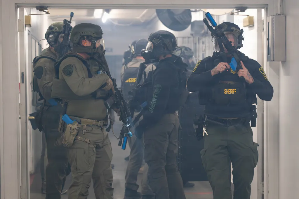 SWAT officers from various agencies participate in a simulated hostage situation during Exercise Sourdough.