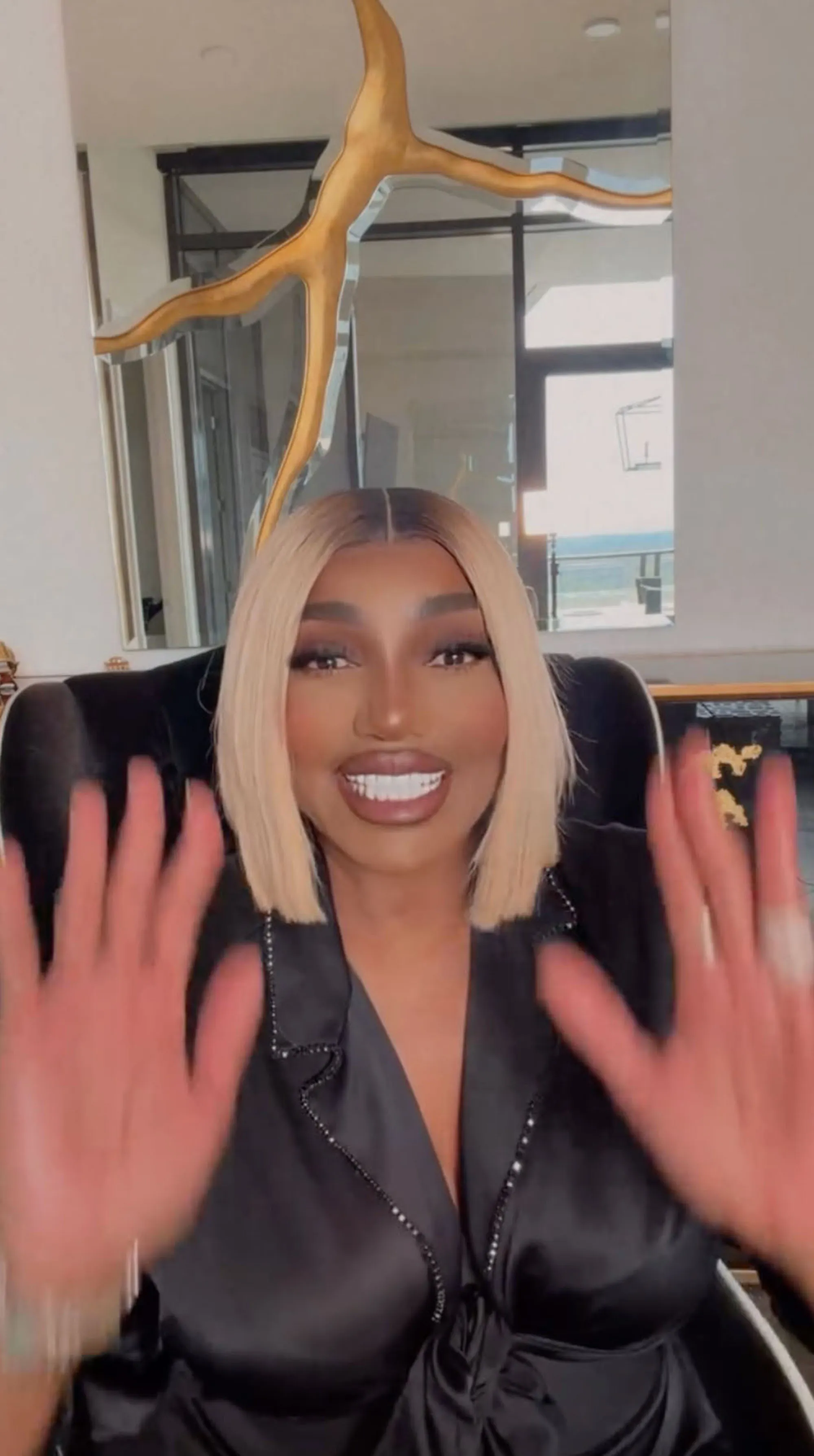 NeNe Leakes posing with her hands up.