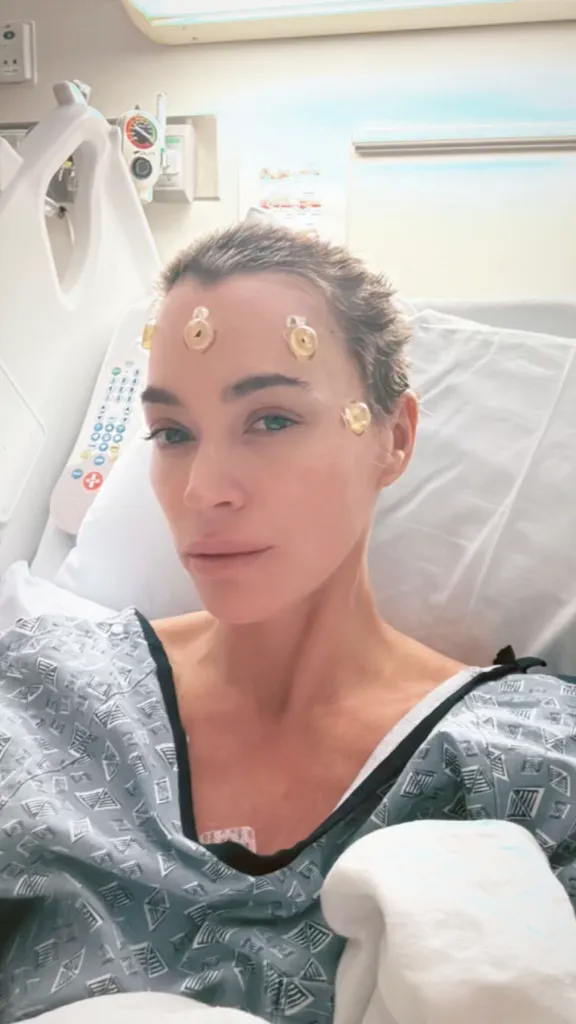 Teddi Mellencamp in a hospital bed with electrodes on her forehead.