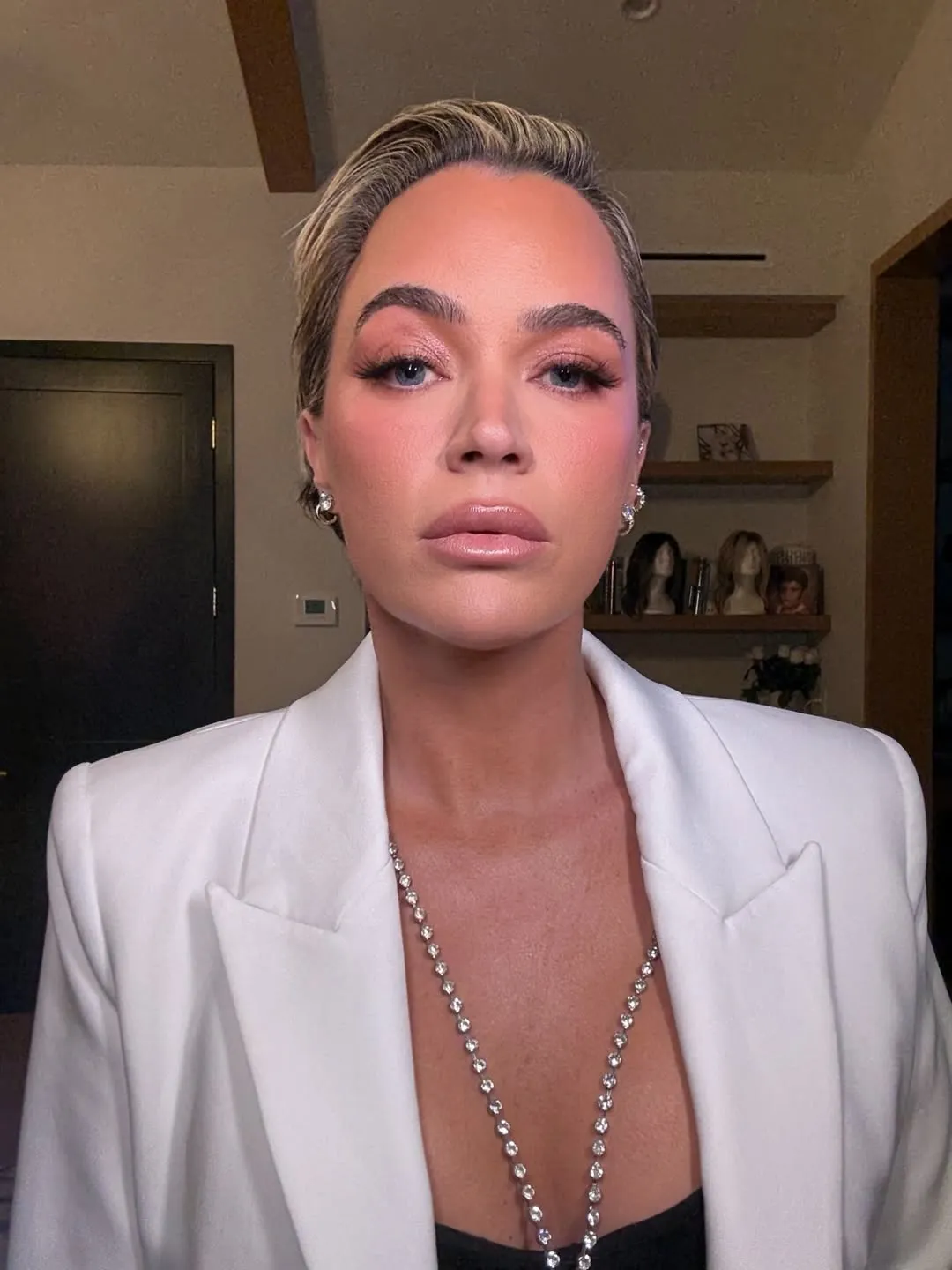Teddi Mellencamp in a white blazer and sparkling necklace.