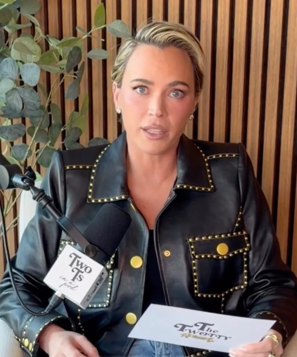 Teddi Mellencamp in a black leather jacket with gold studs speaking into a microphone.