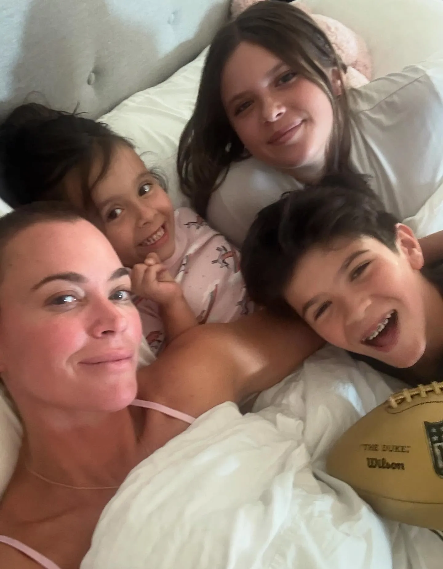 Teddi Mellencamp with her children in bed.