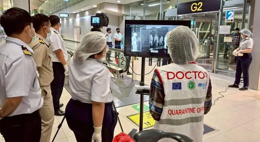 Thai officials screen travelers at an airport for the Nipah virus.