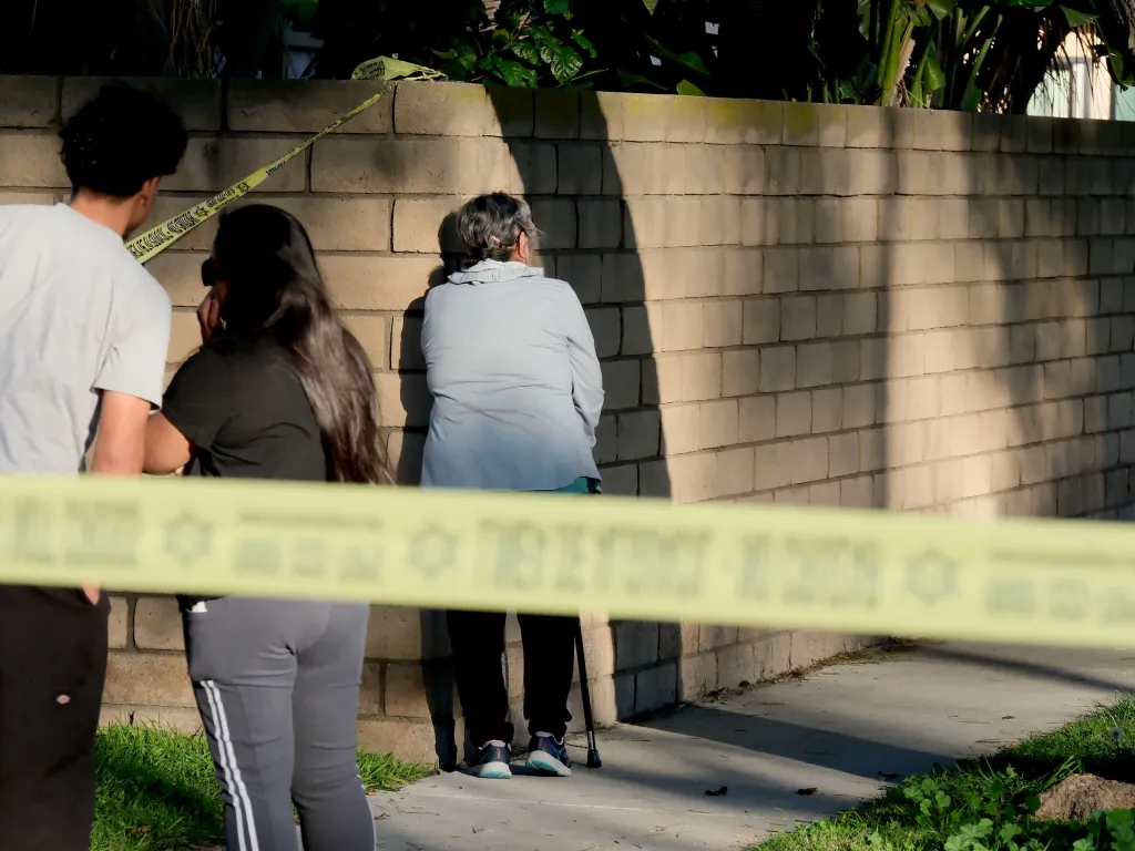 Family members outside the home after the deadly shooting.