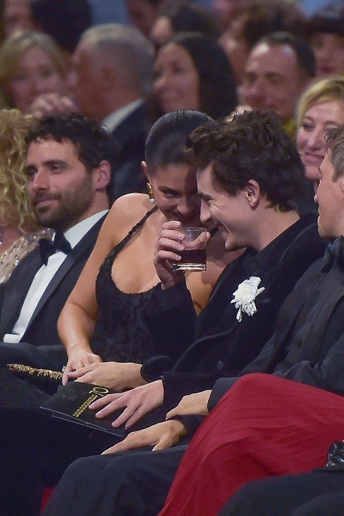 Timothée Chalamet and Kylie Jenner smiling at the David di Donatello Movie Awards in Rome while sitting with Sean Baker.