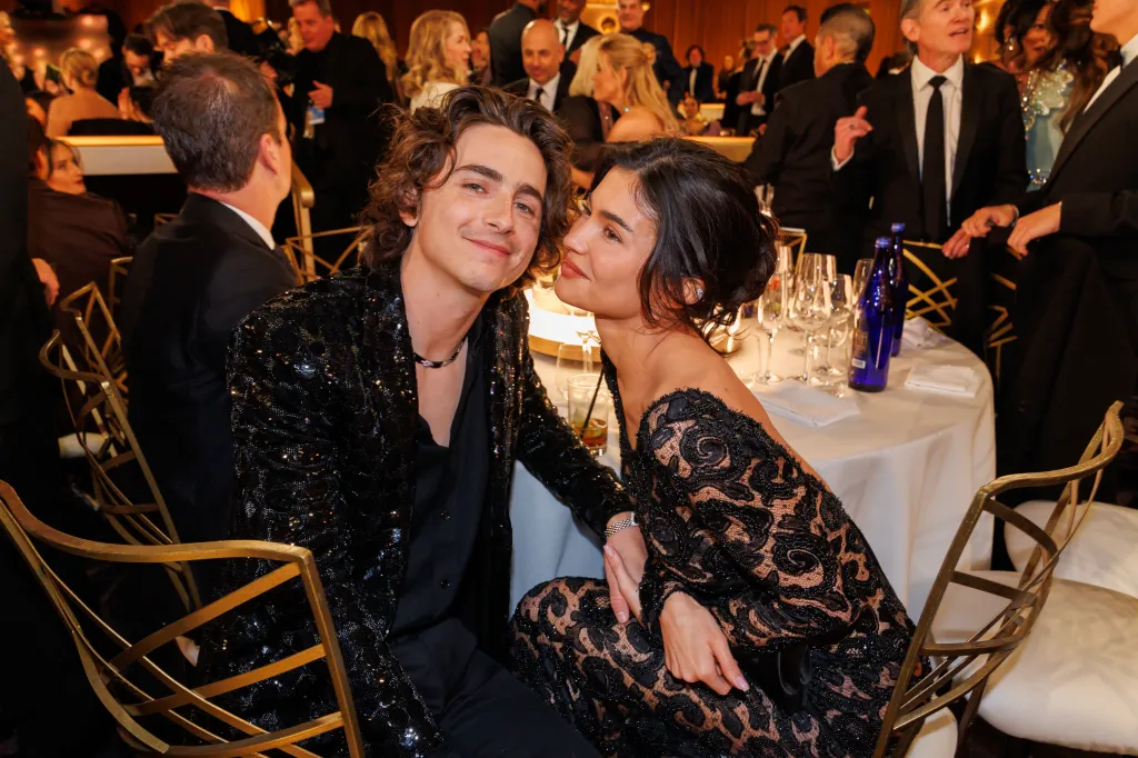 Timothée Chalamet and Kylie Jenner seated at a table at the Golden Globe Awards.