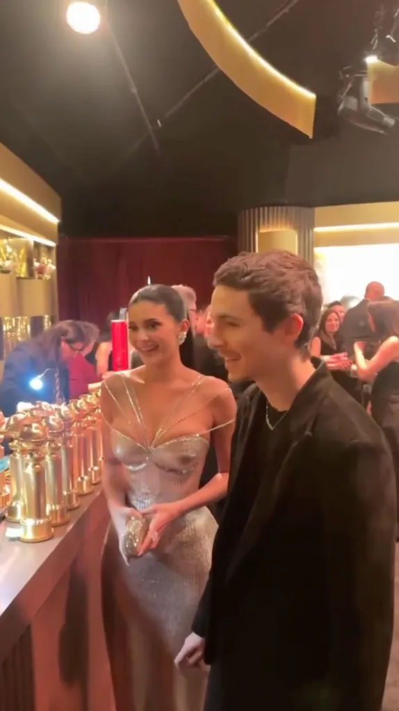 Timothée Chalamet and Kylie Jenner taking a trip to the engraving station at the Golden Globes.