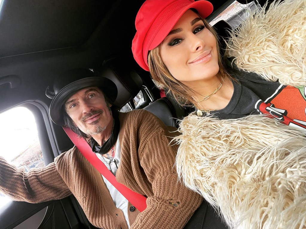 Tommy Lee and Brittany Furlan taking a selfie in a car.