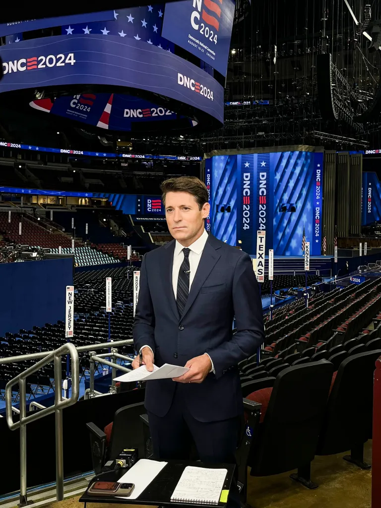 Tony Dokoupil anchors CBS Mornings from the United Center in Chicago, where multiple screens and banners display 