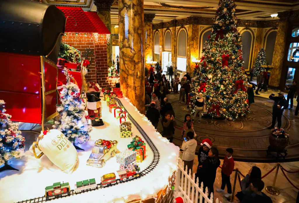 A toy train moves on the roof of a gingerbread house during the sweet structure's unveiling as the Fairmont Hotel kicks off the holiday season.
