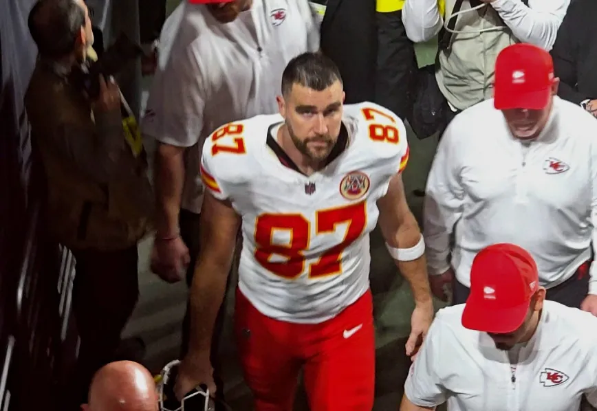 Travis Kelce looks somber as he departs the field after a 12-14 loss.