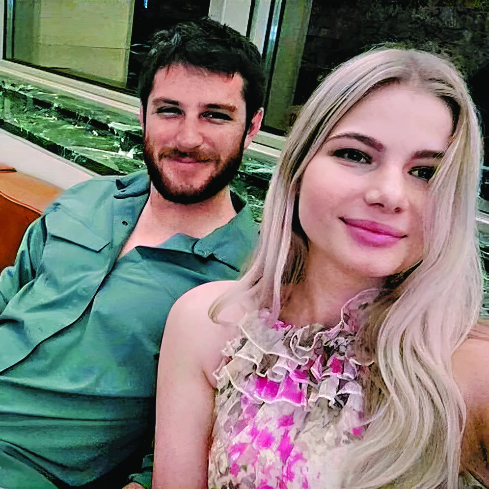 Trevor Reed and girlfriend Lina, sitting and smiling. 