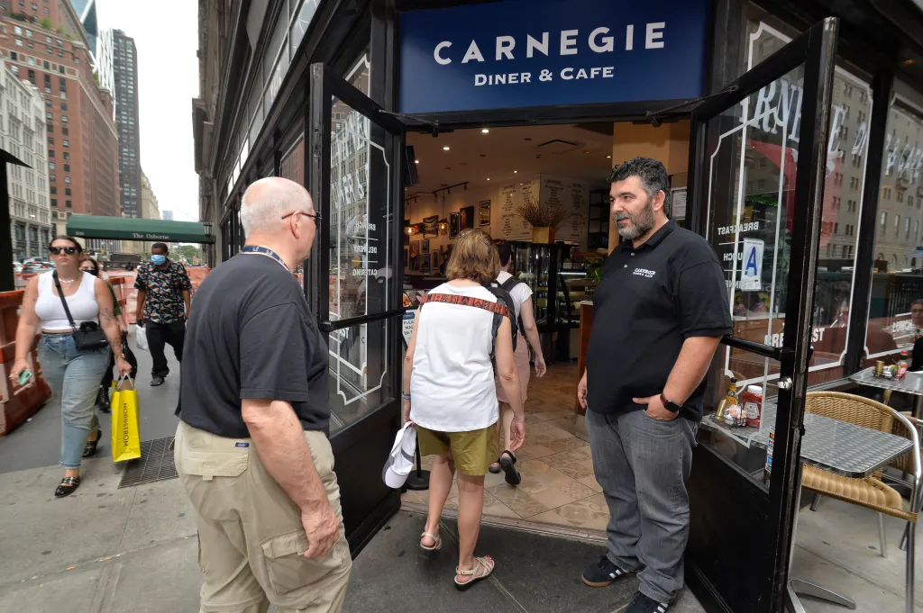 Owner Stathis Antonakopoulos stands outside Carnegie Diner, looking towards the street.