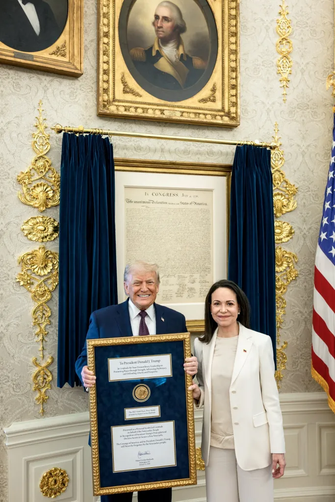 U.S. President Trump and Venezuelan opposition leader Maria Corina Machado holding a framed Nobel Peace Prize.