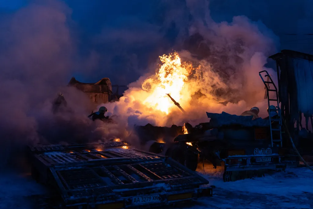 Ukrainian first responders battle a fire at the site of a Russian strike in Kyiv on Jan. 24, 2026.