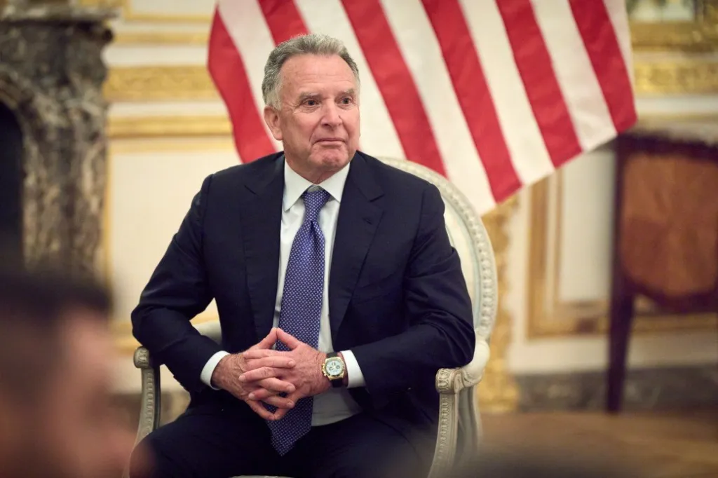 US Special Envoy Steve Witkoff seated in a chair with the US flag in the background.
