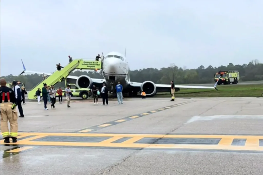 Passengers evacuating a United Airlines jet that rolled off the runway onto grass at George Bush Intercontinental Airport in Houston.