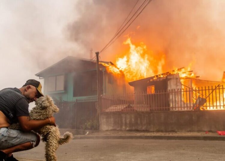 Wildfires race across Chile, leaving 18 dead and forcing 50,000 to flee
