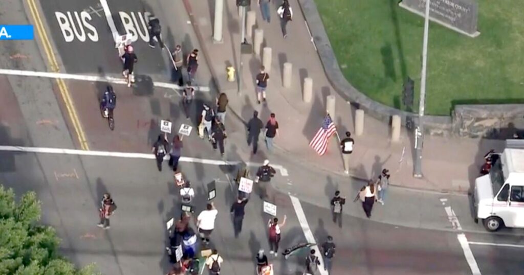 Anti-Trump protesters join ‘Free America’ walkout in downtown L.A. and across SoCal