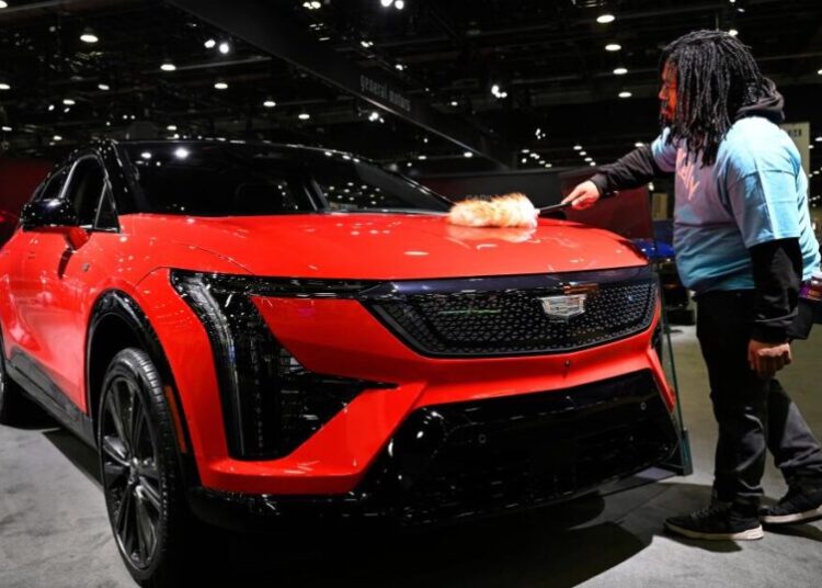 At Detroit auto show, spotlight dims for EVs