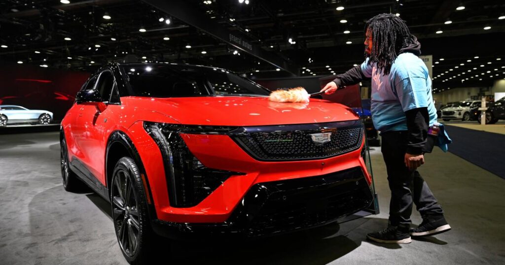 At Detroit auto show, spotlight dims for EVs