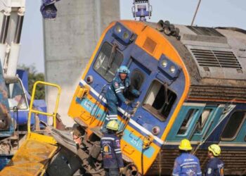 A construction crane falls onto a moving train in Thailand, killing at least 32 people