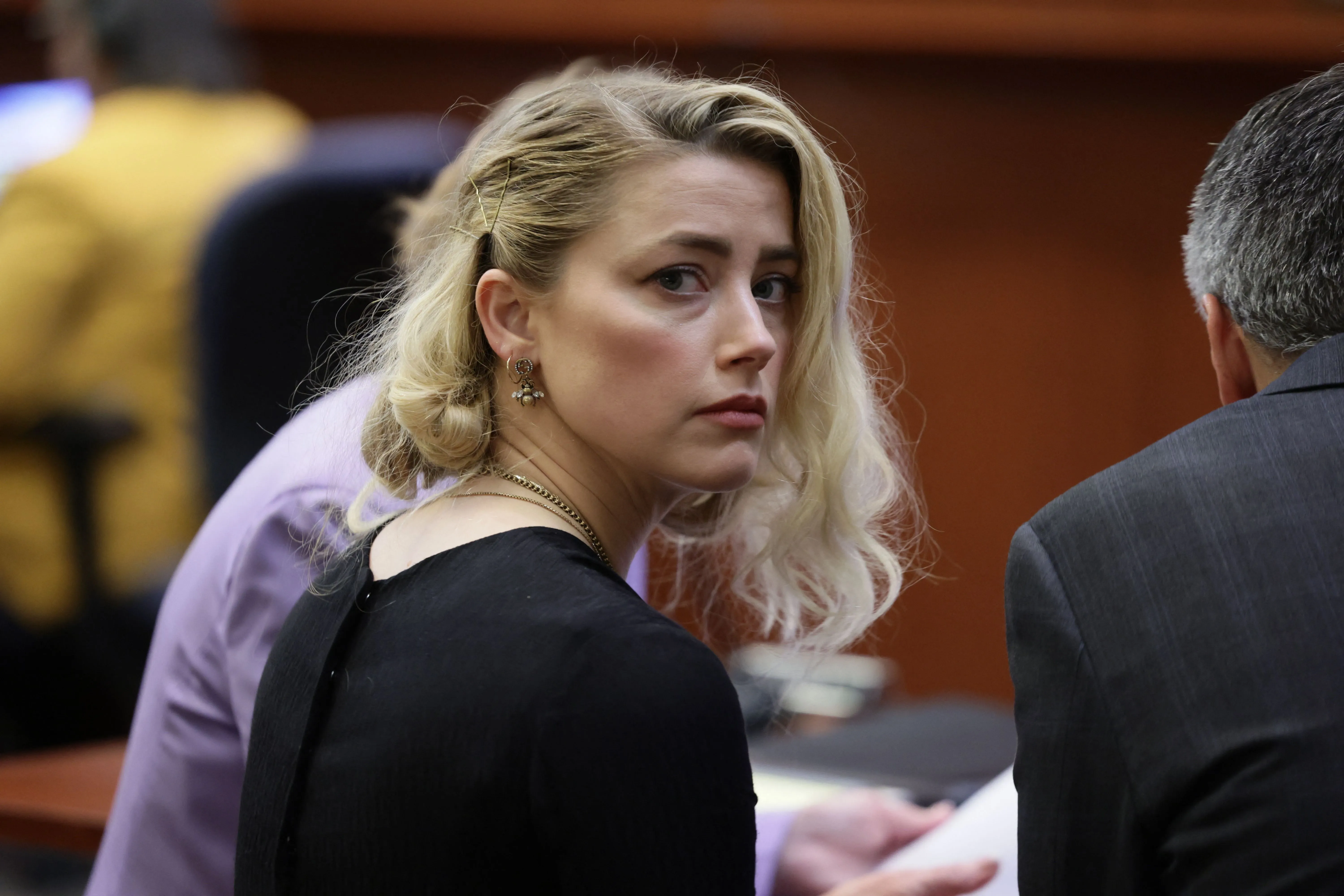 Actress Amber Heard looks back while waiting for the verdict in her defamation trial.