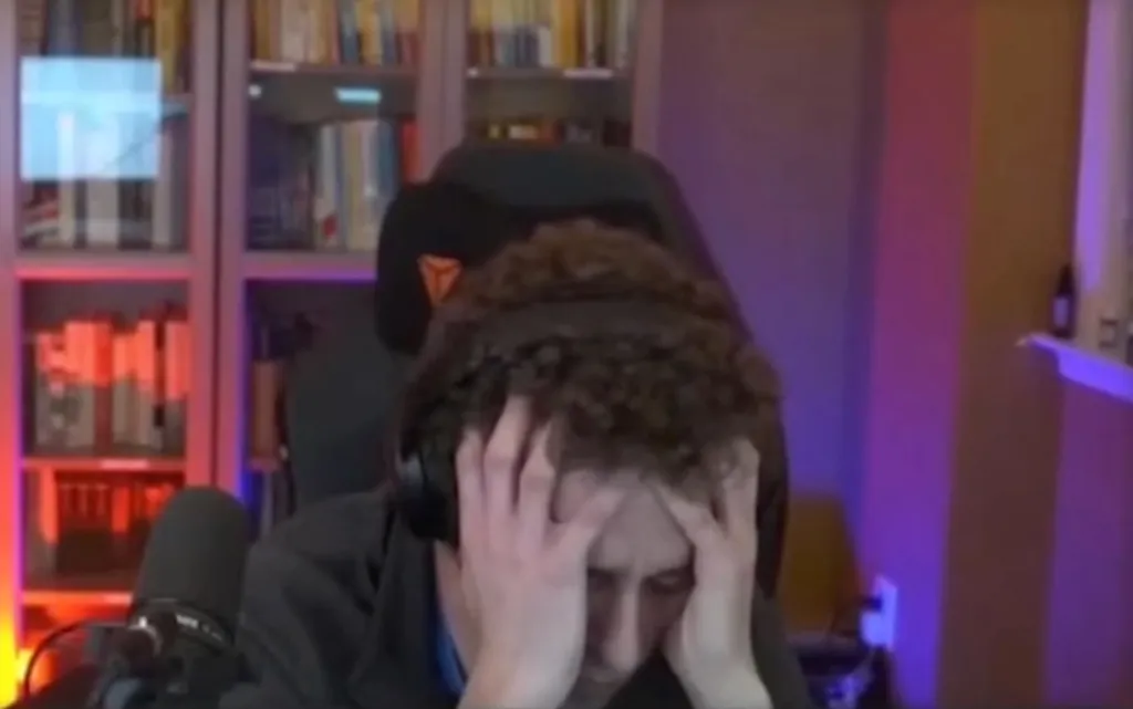 Daniel Naroditsky with his hands on his head, looking distressed.