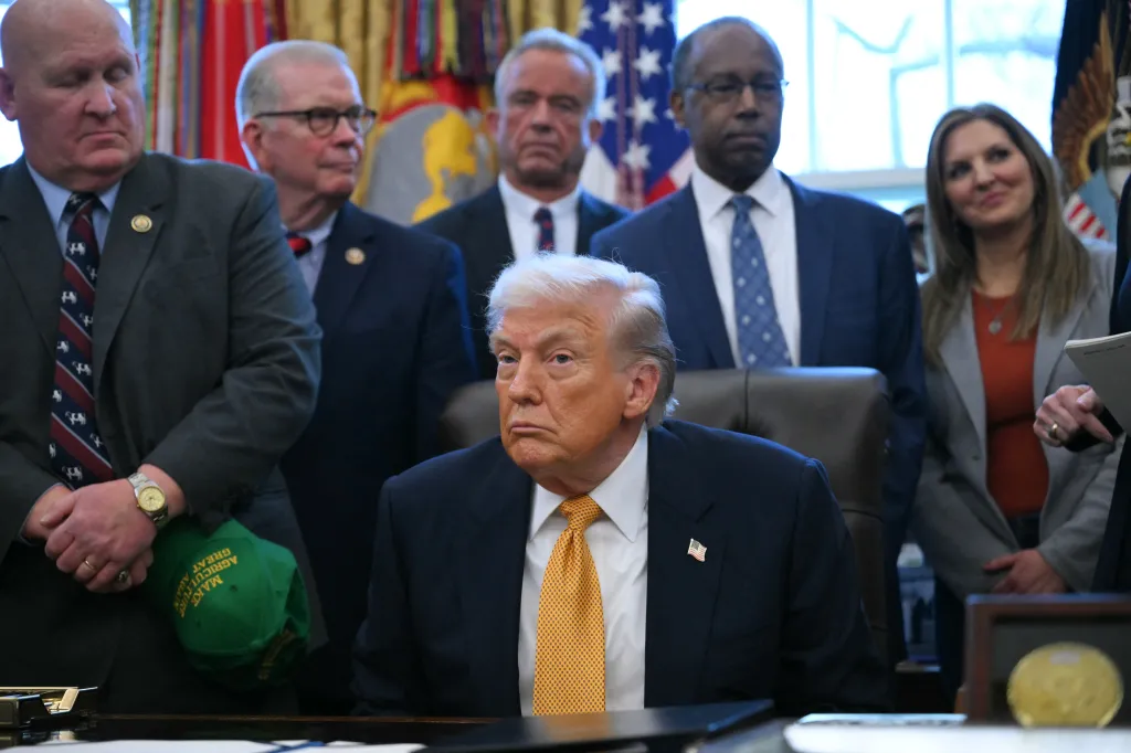 US President Donald Trump looks on before signing a bill in the Oval Office.