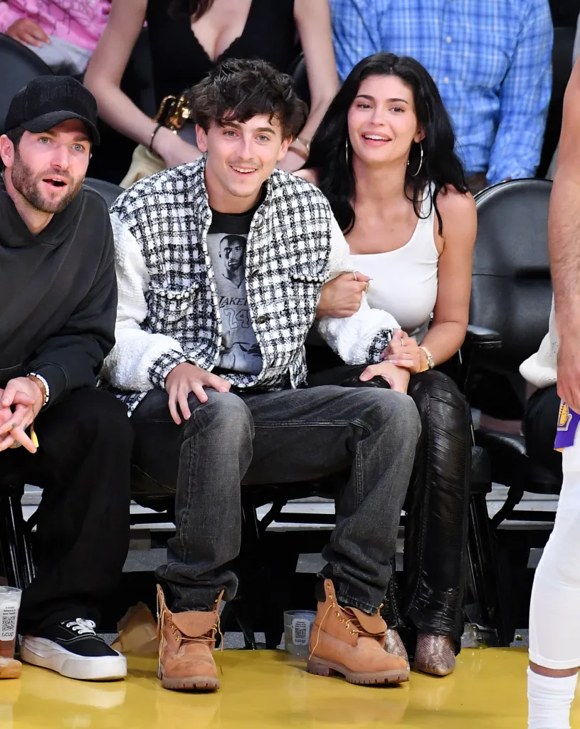 Timothée Chalamet and Kylie Jenner attend a basketball game.