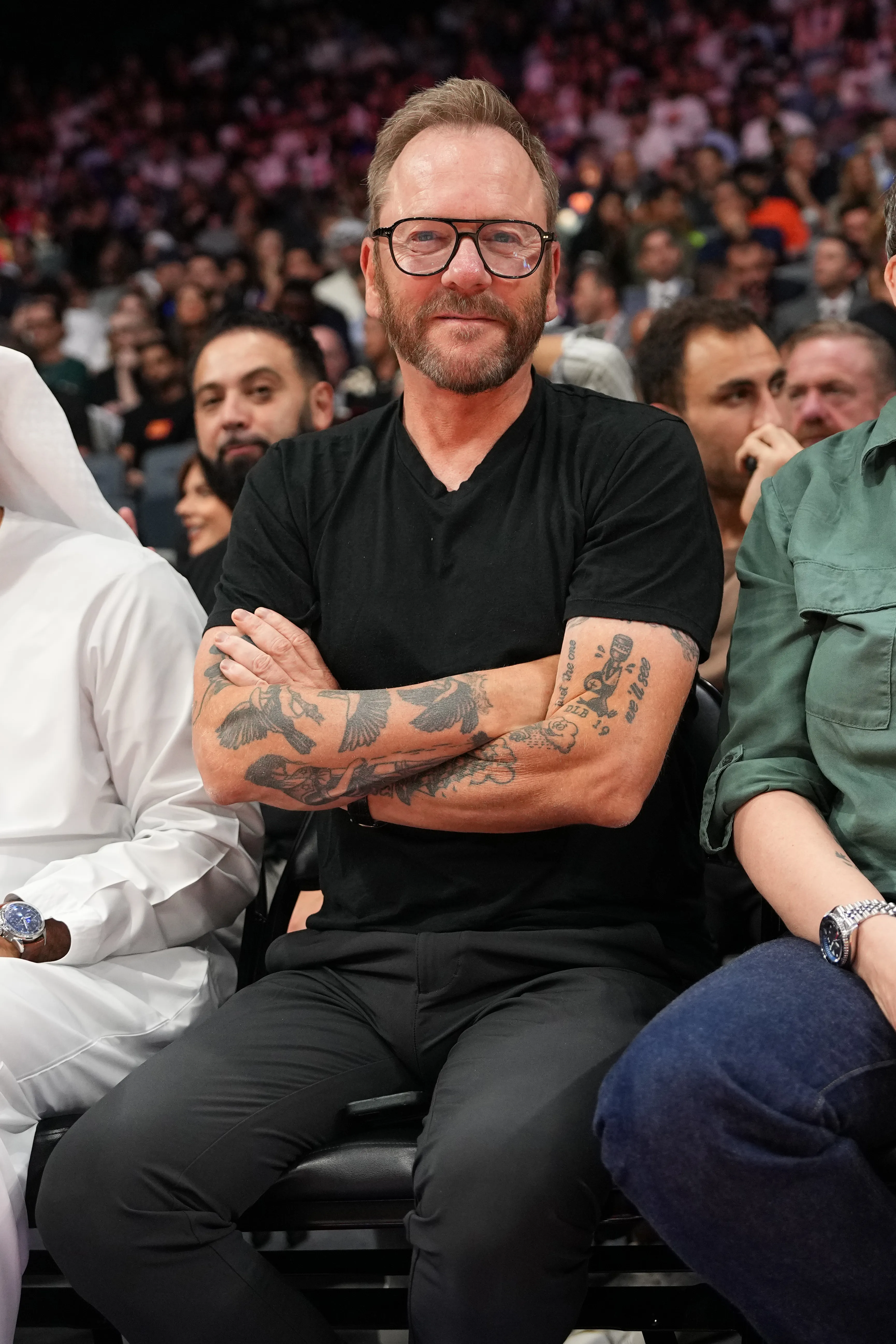 Kiefer Sutherland watching a basketball game.