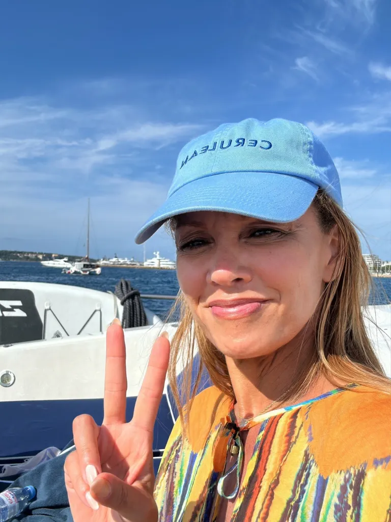 Vanessa Williams smiling and making a peace sign on a boat.