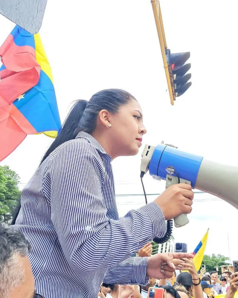 Venezuelan activist María Oropeza speaking into a megaphone.