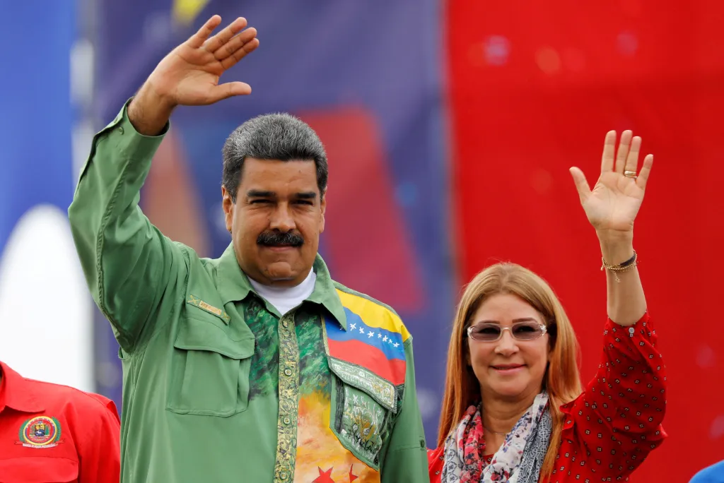 Venezuela's President Nicolas Maduro and his wife Cilia Flores greet supporters during his closing campaign rally.