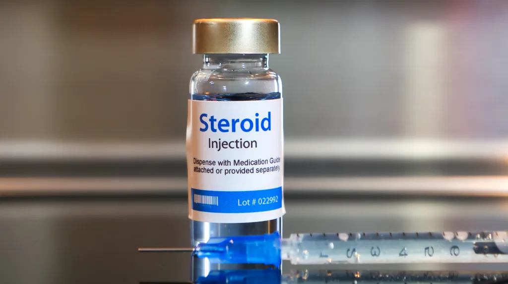 A vial of steroid injection with a syringe.