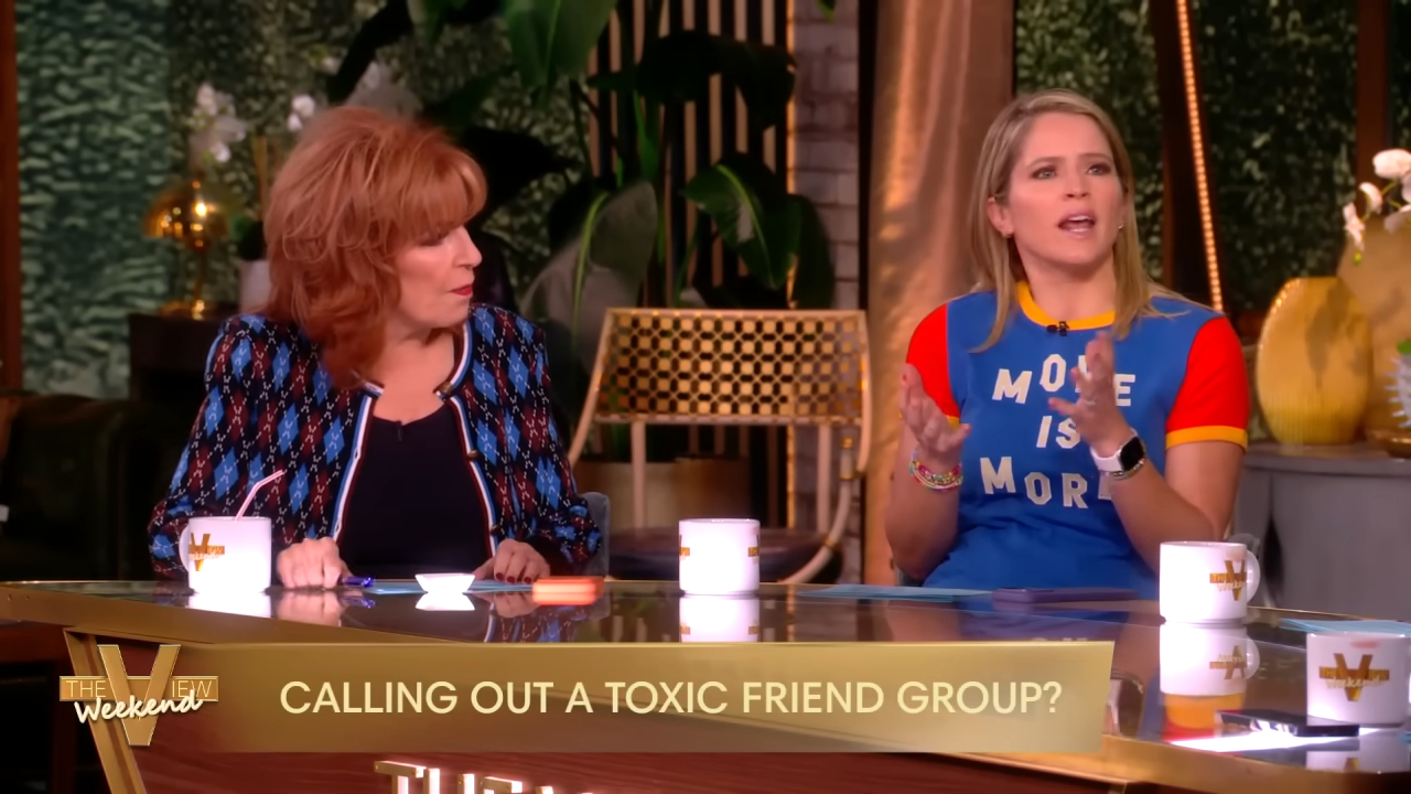 Two women on a television set, one in a blue shirt with 