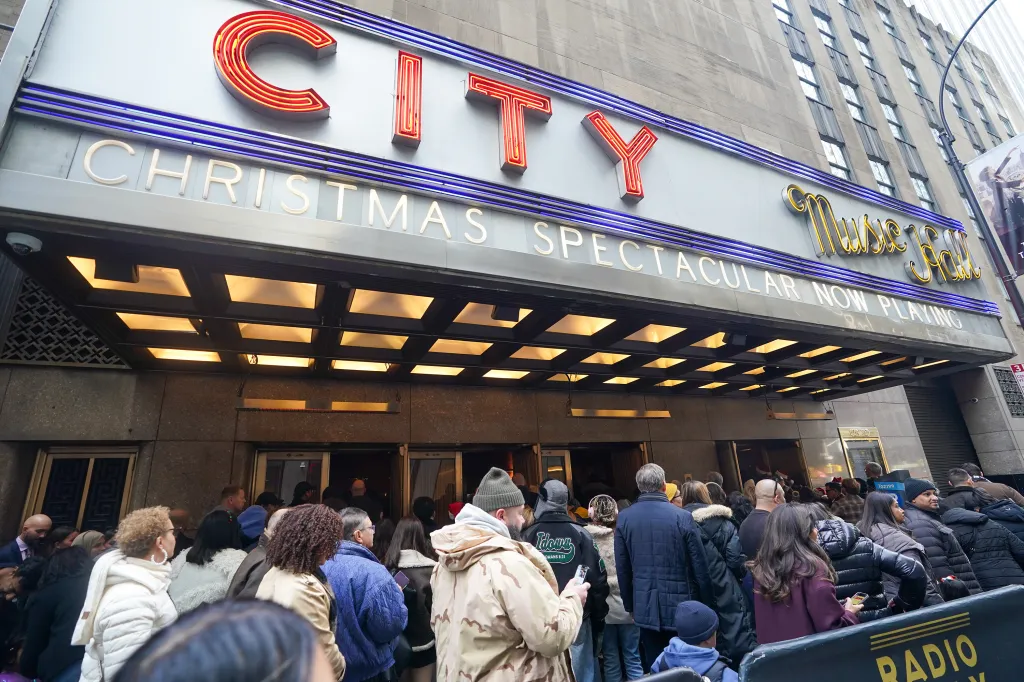 People waiting in line to enter Radio City Music Hall for the Annual Christmas Show.