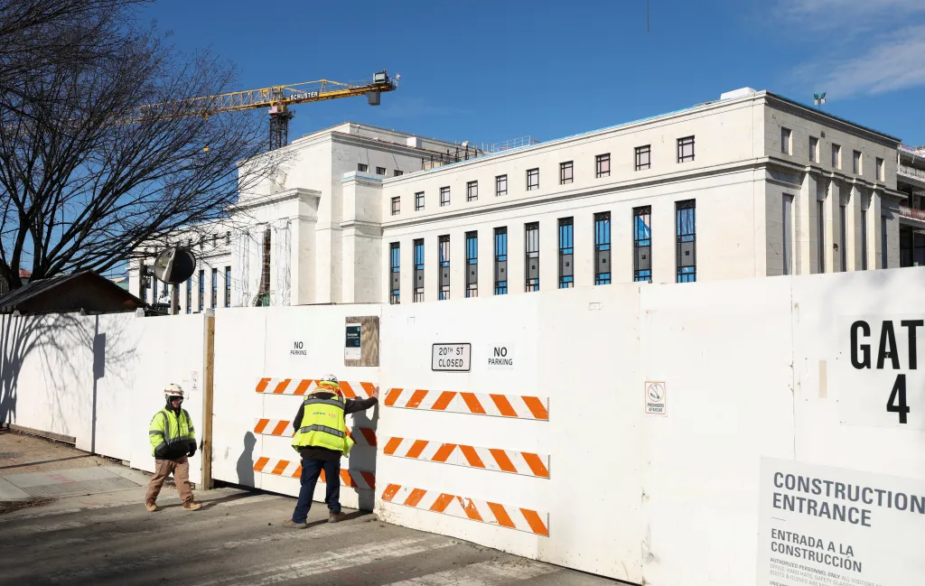 A worker enters the construction site of the Federal Reserve headquarters, after U.S. President Donald Trump renewed his threat to bring a lawsuit against Federal Reserve Chair Jerome Powell over Powell's management of renovations of the building, in Washington, D.C., U.S., January 12, 2026. REUTERS/Kevin Lamarque