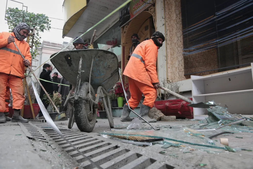 Workers clean debris and broken glass after an explosion in Kabul, Afghanistan.