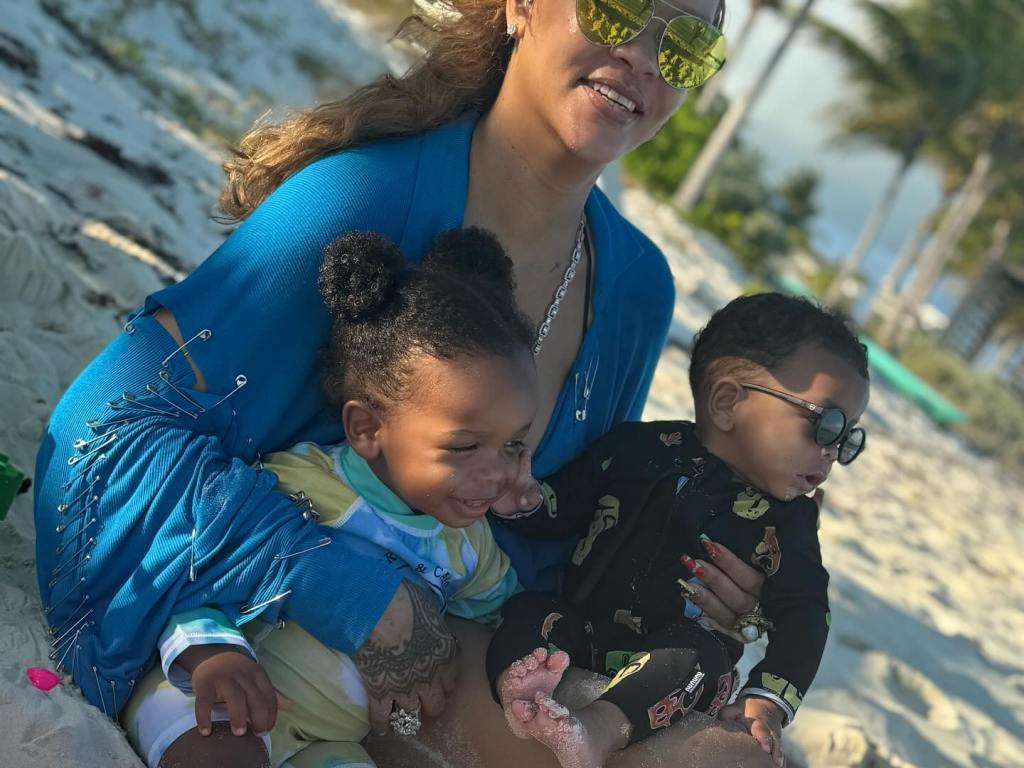 Rihanna with her two children on a beach.
