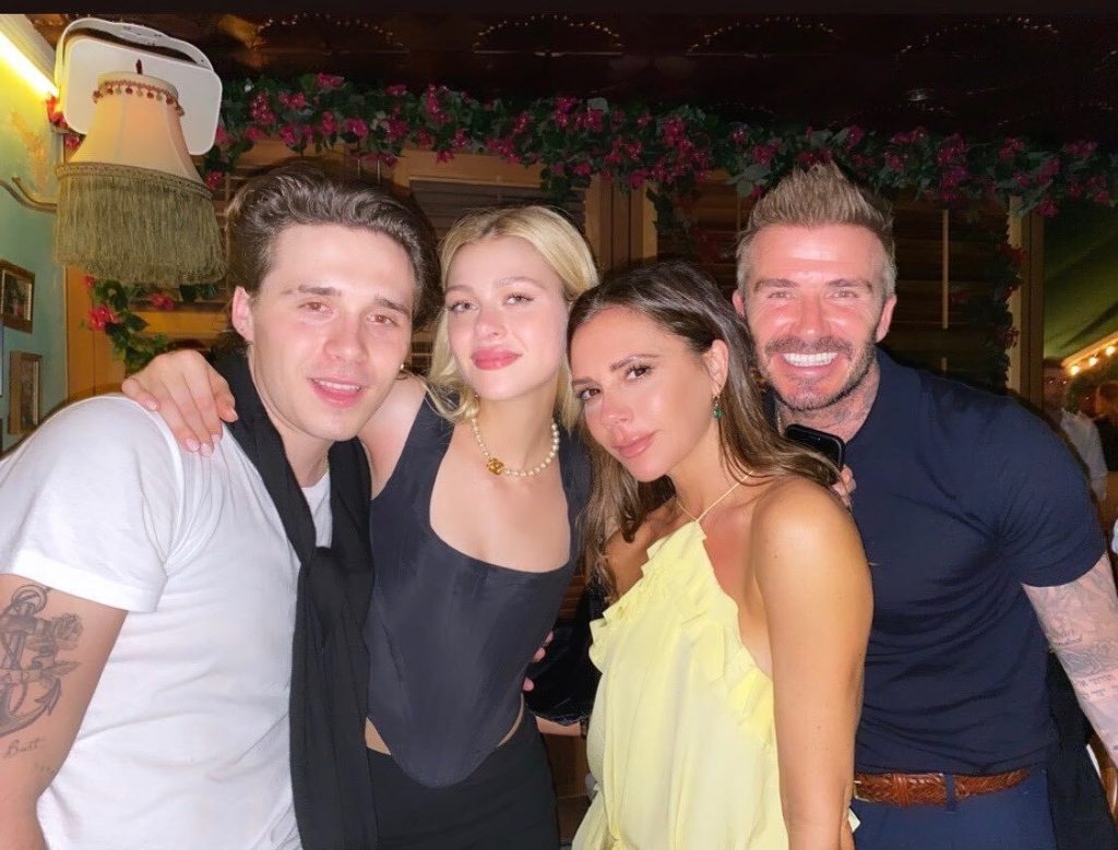 Brooklyn Beckham, Nicola Peltz, Victoria Beckham, and David Beckham posing together.